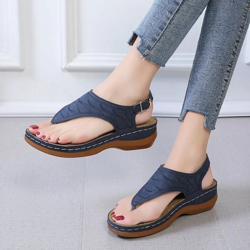 Women's casual wedge heel flip flop sandals with an adjustable back strap in solid colours.