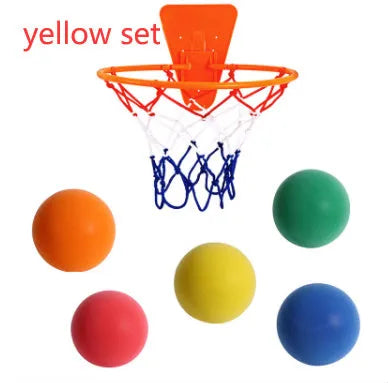 Assorted bright coloured silent high-density foam basketballs in different sizes with a basketball frame.