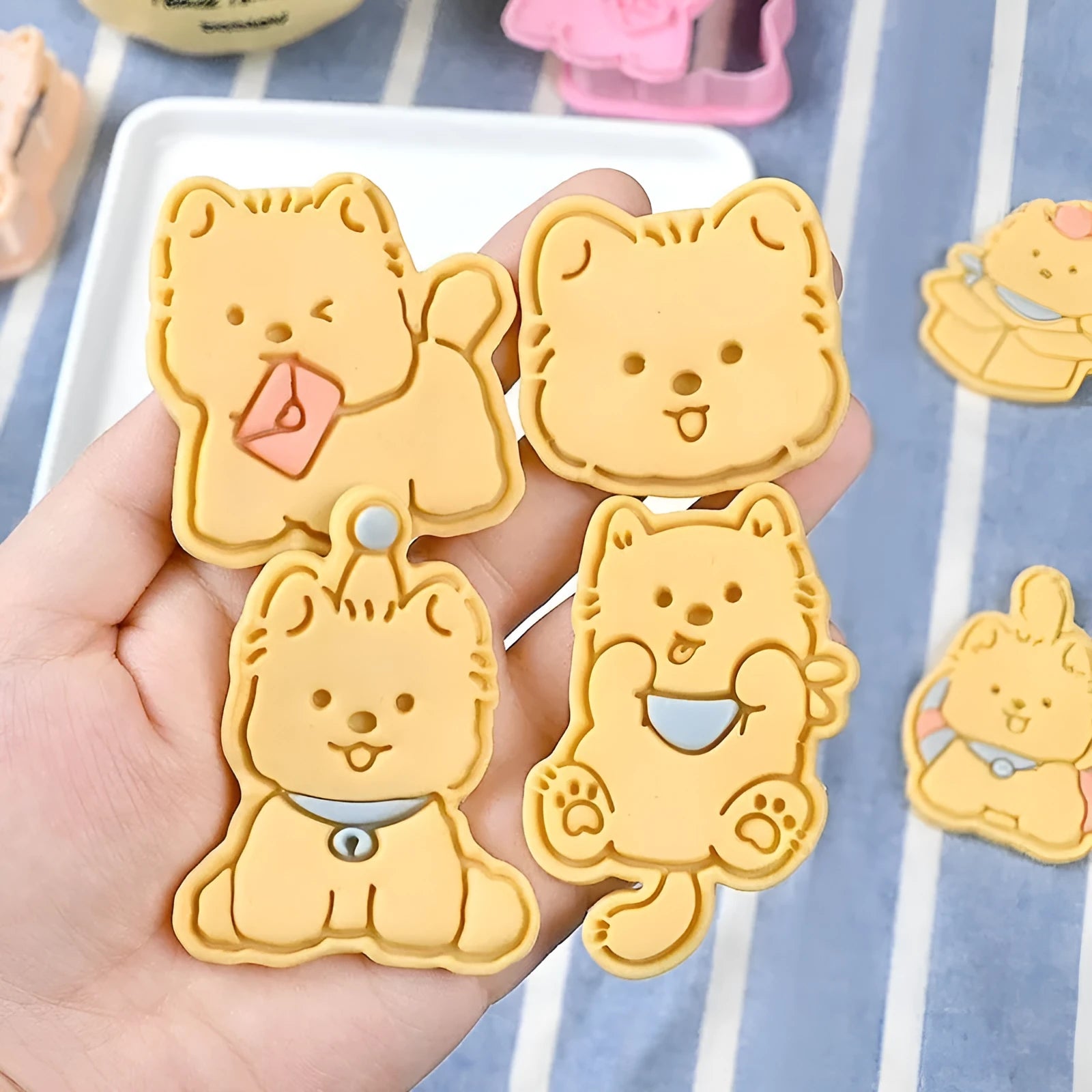 Three dimensional plastic biscuit mold showing puppy head and birthday hat designs