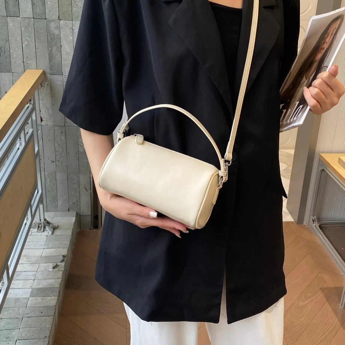 Soft genuine leather cylindrical crossbody phone bag in street style with sewing thread detailing