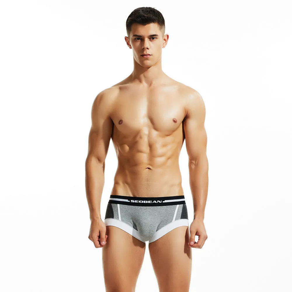 Men's cotton low waist boxer shorts in red, dark blue, and light grey colours laid flat.