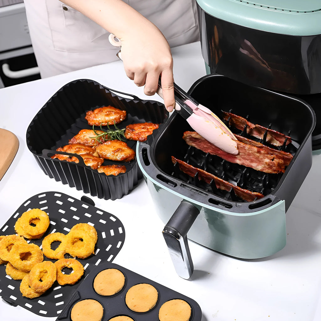 Black silicone baking tray set for air fryer including 4 square trays for cake, jelly, and pudding baking.