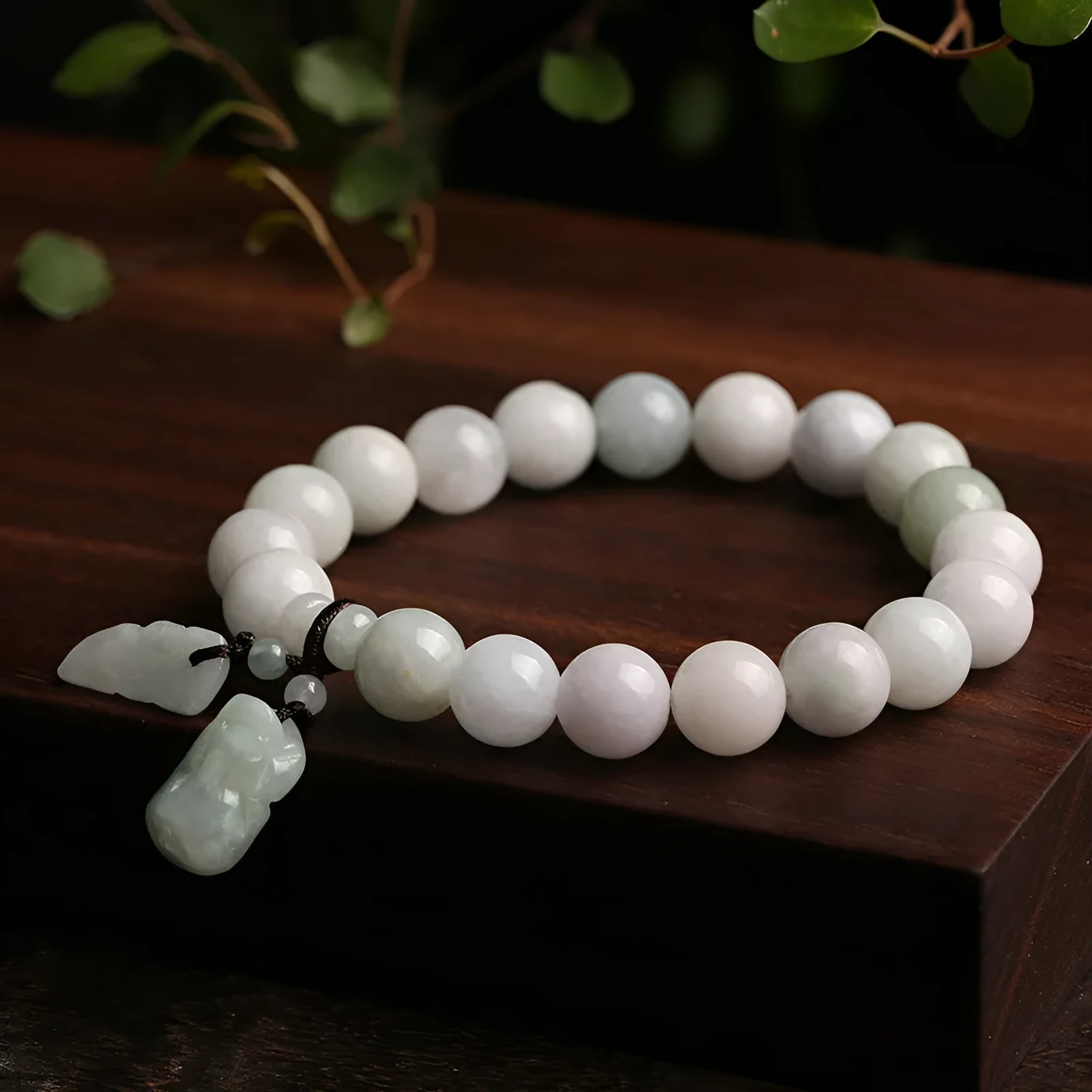 Natural green jade bracelet with hanging geometric charms including an Apple and a Maitreya Buddha pendant.