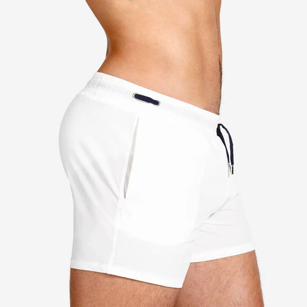 Men's solid colour polyester sports shorts with mesh lining, shown in Army Green, for swimming and fitness.