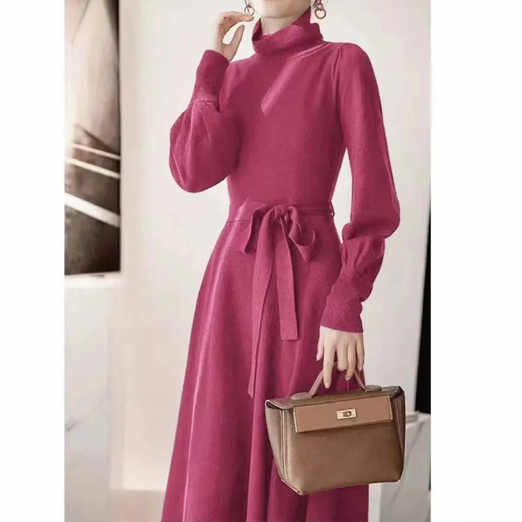 Women's knitted turtleneck dress with long sleeves, elastic waist, and a loose A-line skirt in a solid colour.