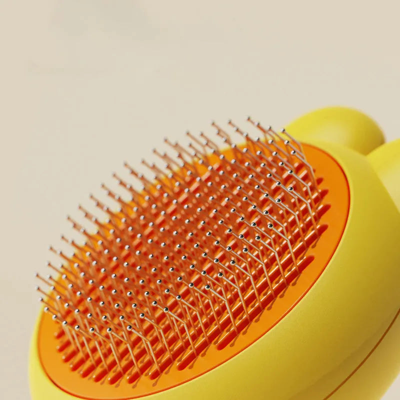 Self-cleaning pet grooming brush with release button in green, pink, purple or yellow colours