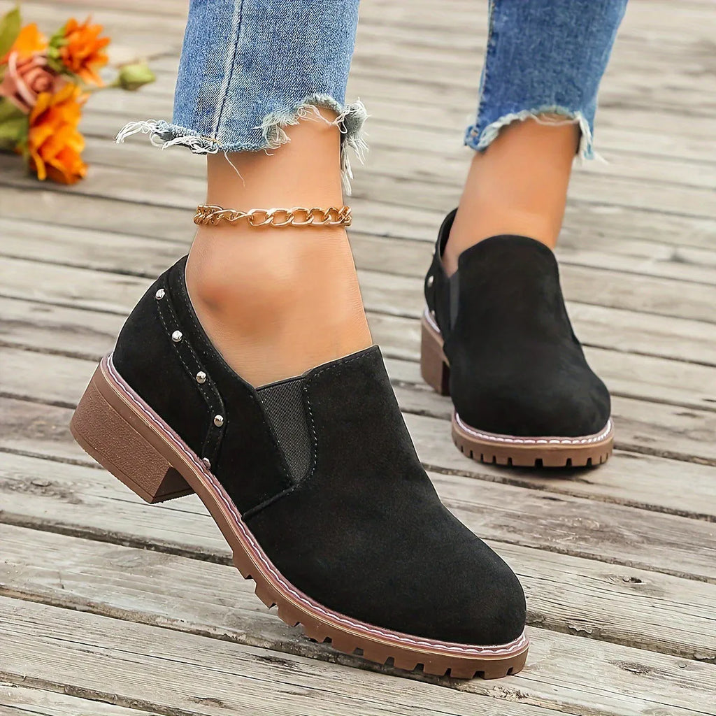 Women's light brown suede ankle boots with a thick low heel and elastic band fastening.