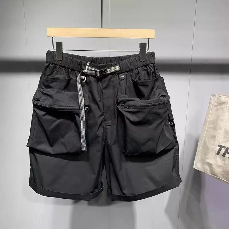 Man wearing large size black loose-fit work shorts with pockets, showing above-the-knee length.