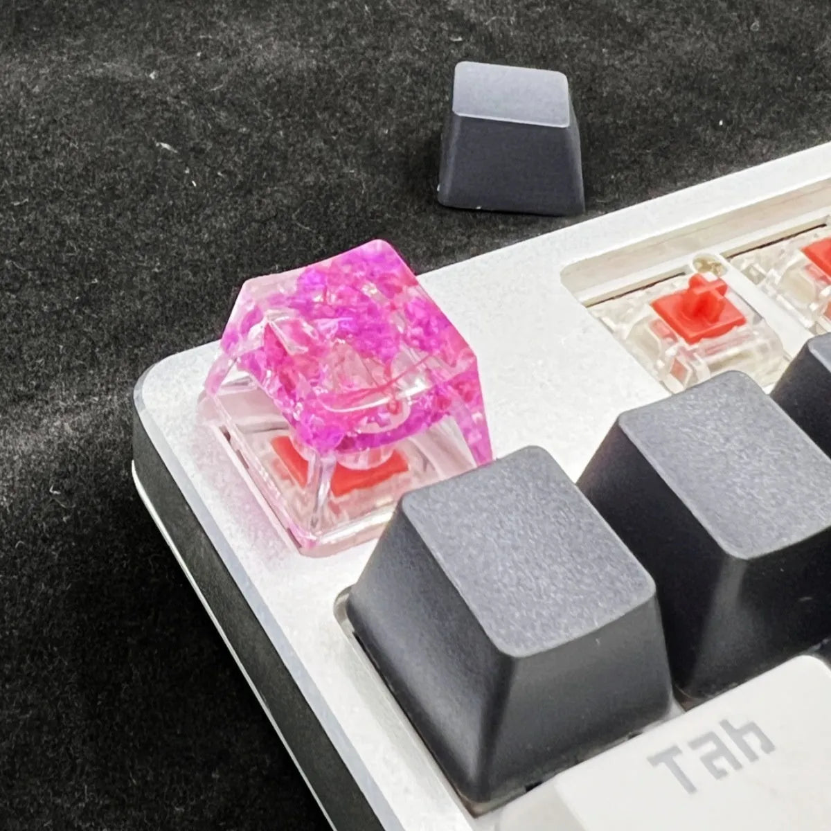 Single resin mechanical keyboard keycap with high transparency and embedded starry sky design, shown in violet colour.
