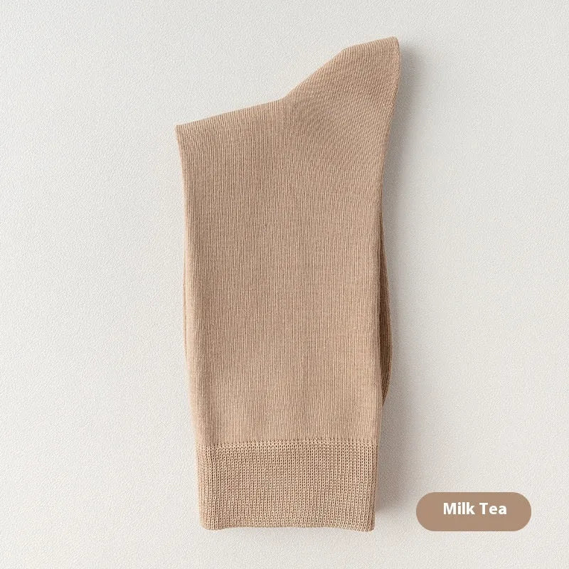 Mid-calf men's socks in solid colours made from combed cotton, shown in a stack.