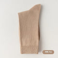 Mid-calf men's socks in solid colours made from combed cotton, shown in a stack.