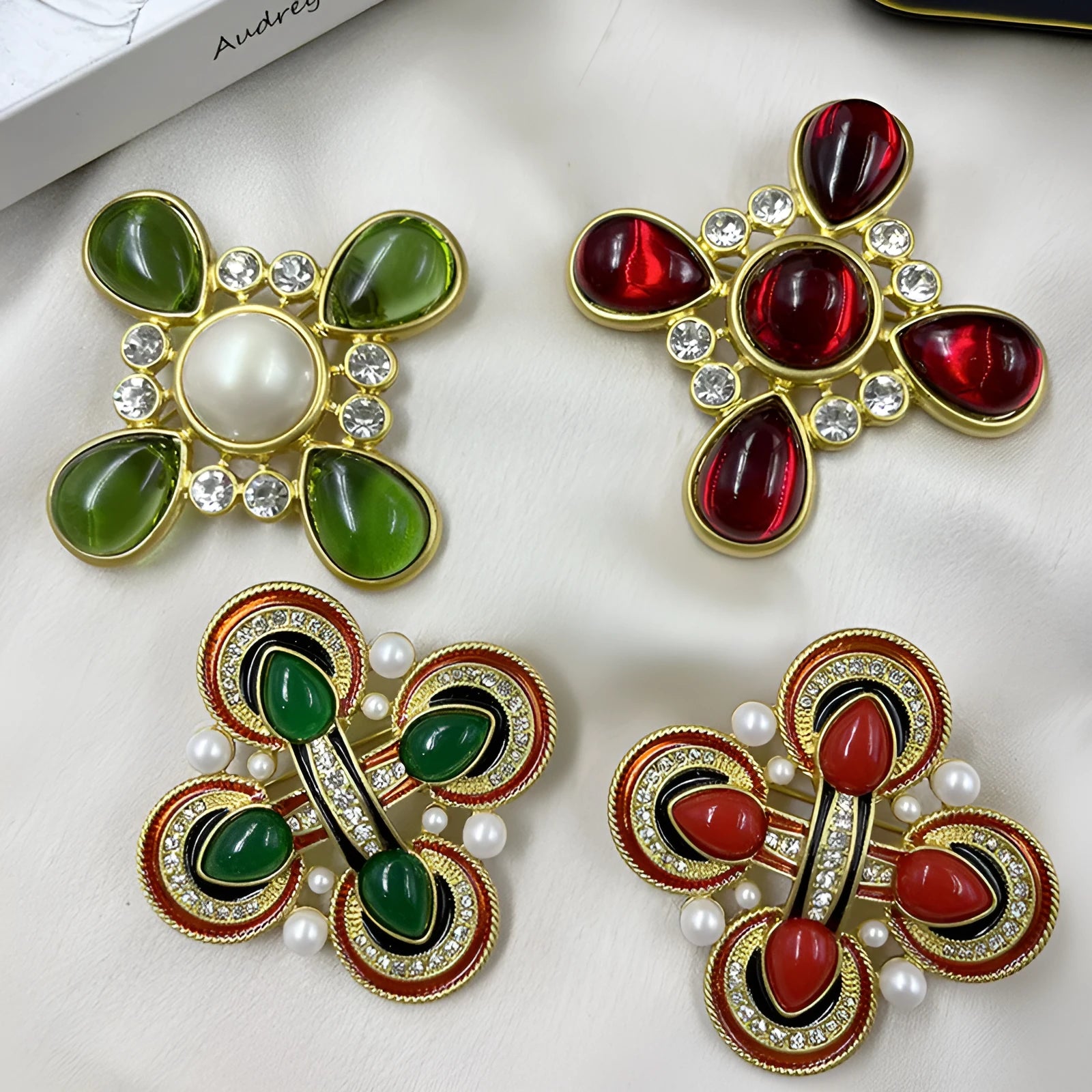 Close-up of a medieval-style baroque cross brooch with crystal decoration on a metal base.