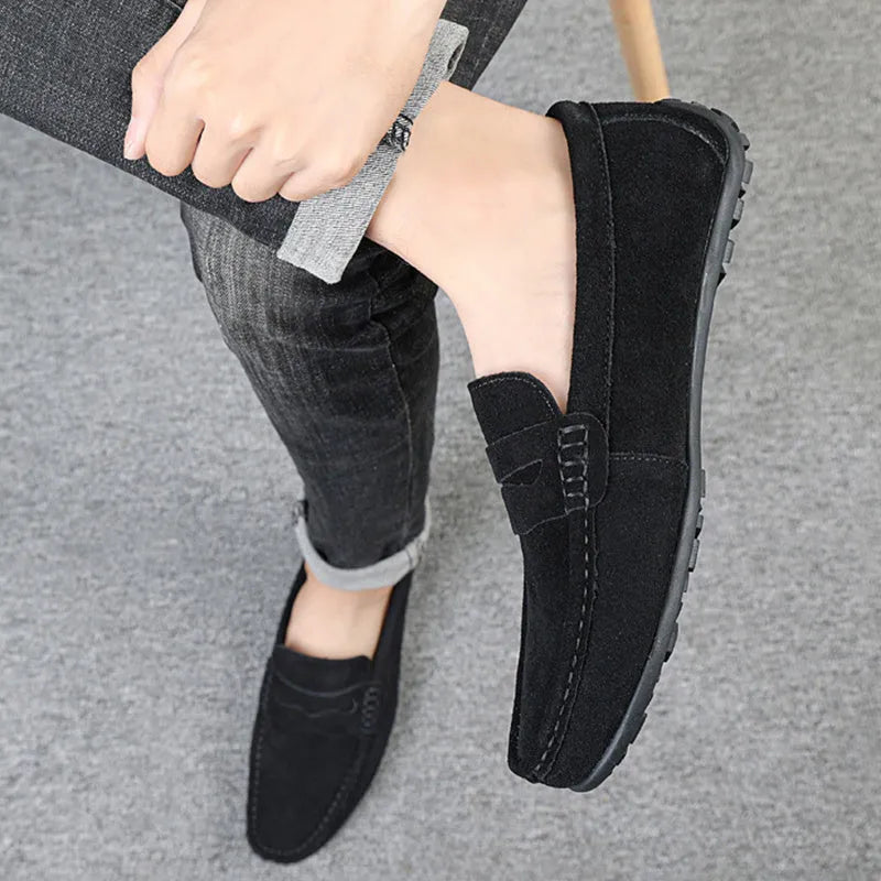 Men's suede slip-on loafers in a solid colour with a round toe and flat rubber sole.
