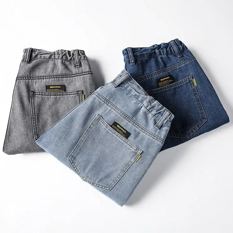 Men's loose straight cotton jeans in dark blue, light blue, and gray with mid-waist zipper fly