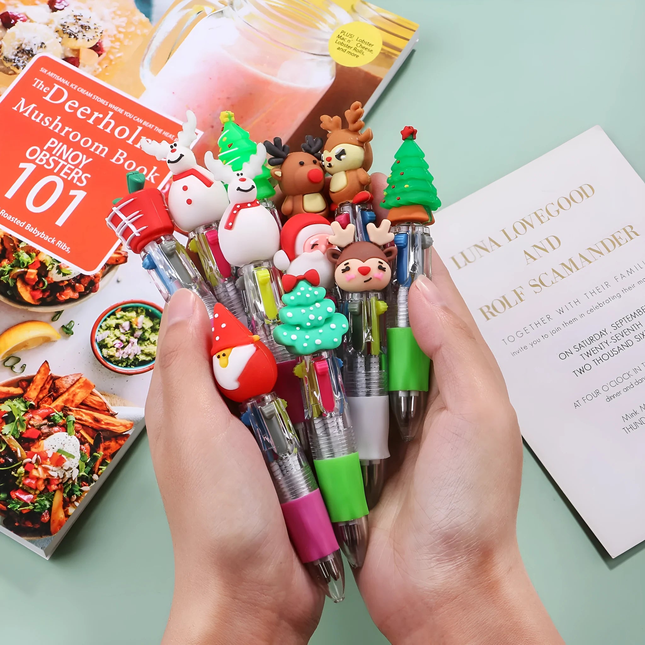 Compact 11cm Christmas four-colour press pen with festive designs including reindeer and snowmen.