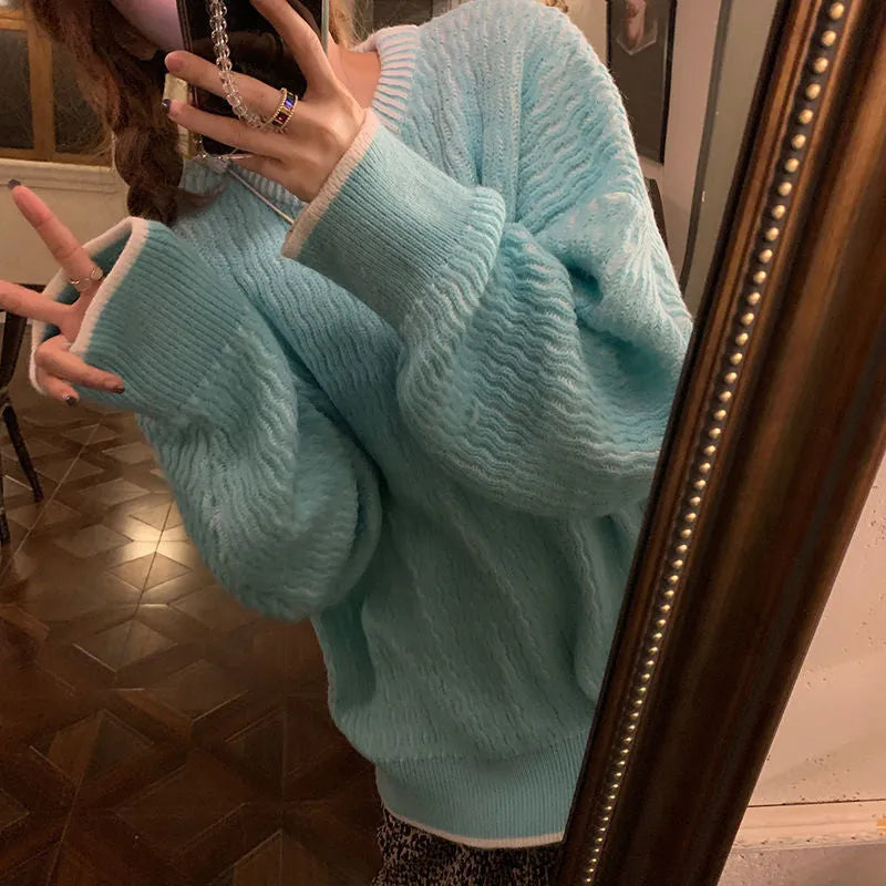 Women's loose blue retro pullover sweater with regular sleeves on a hanger