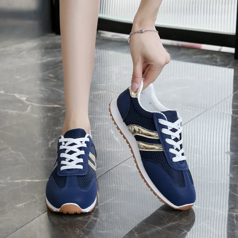 Blue women's casual sports shoes with lace-up front, cross shoulder straps, and a flat non-slip rubber sole.
