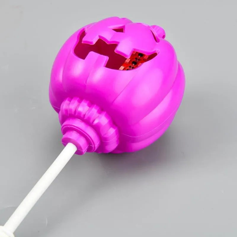 Plastic pumpkin-shaped decorative lamp with USB cable, showing purple or yellow light option.