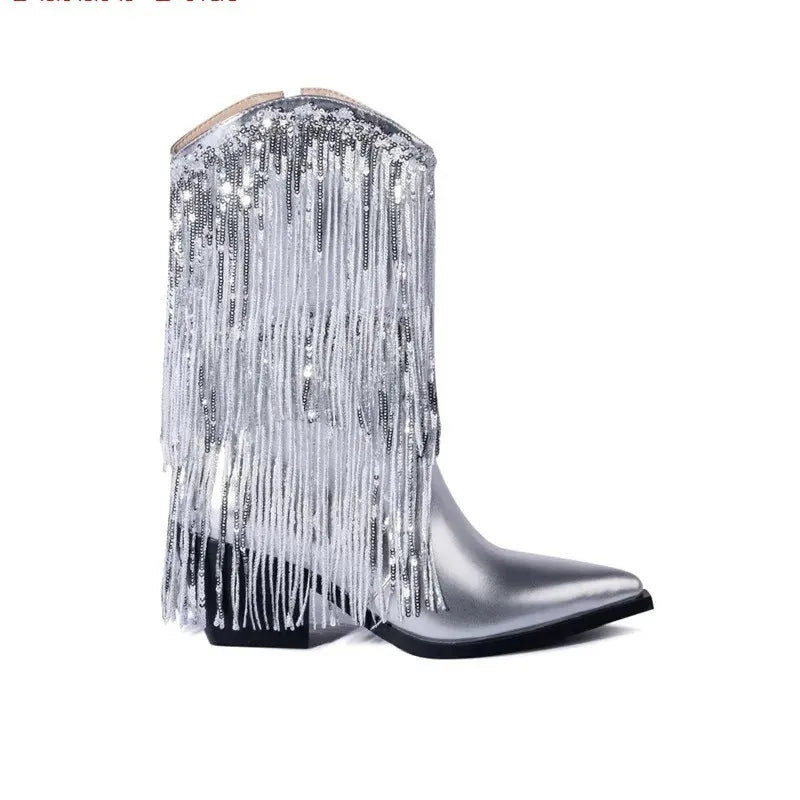 Women's black chunky heel tassel boots with pointed toe and super high stiletto heel on a plain background.