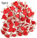 Five small solid wood heart-shaped clips in different colours showing handmade craft details