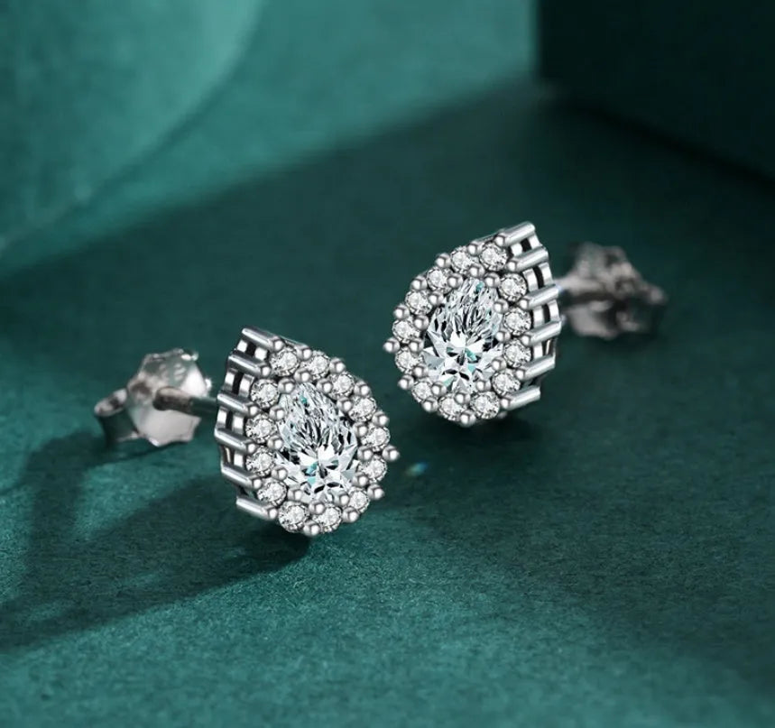Close-up of a pair of polished silver water drop shaped ear studs on a 925 sterling silver post.