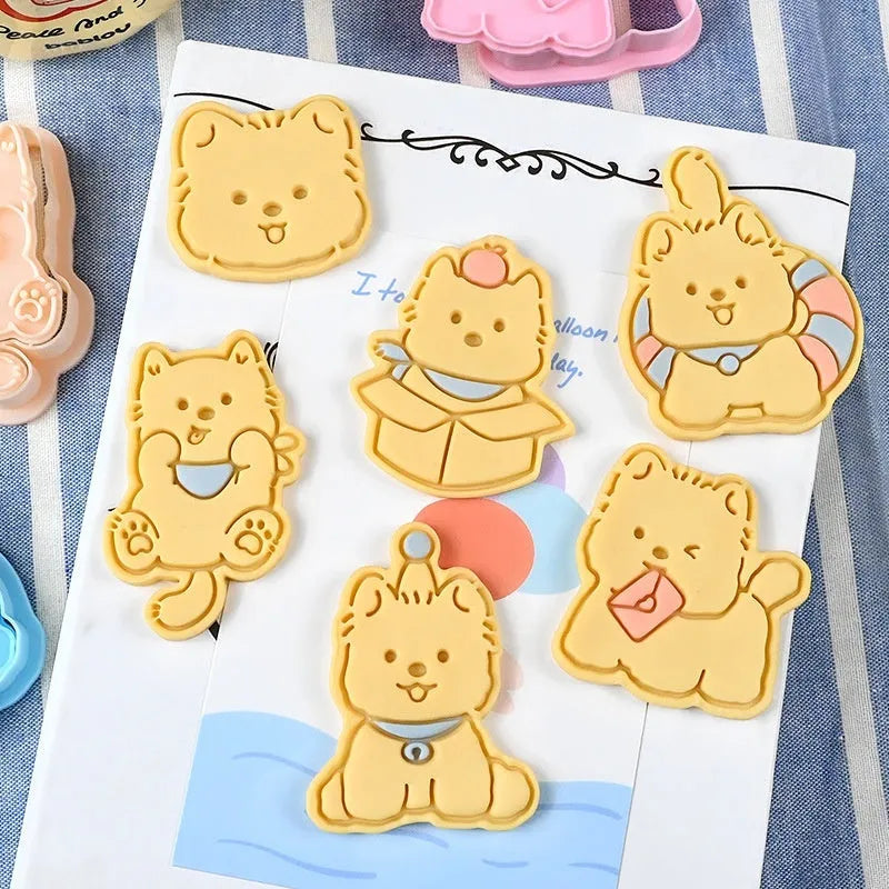 Three dimensional plastic biscuit mold showing puppy head and birthday hat designs
