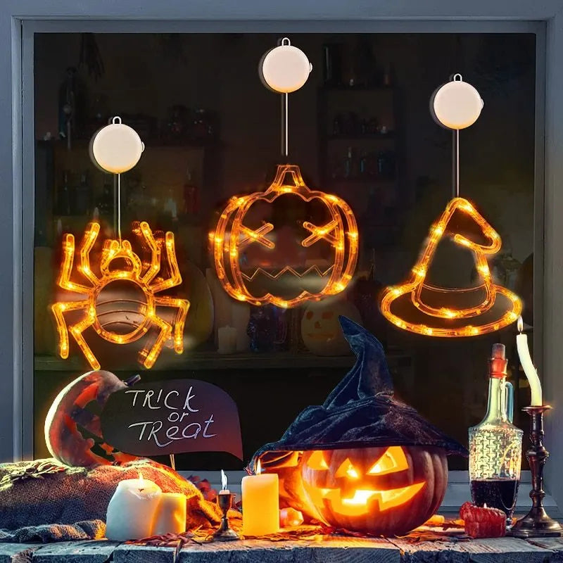 Set of seven battery-powered Halloween LED hanging lights with ghost, spider, and pumpkin designs for window decoration.