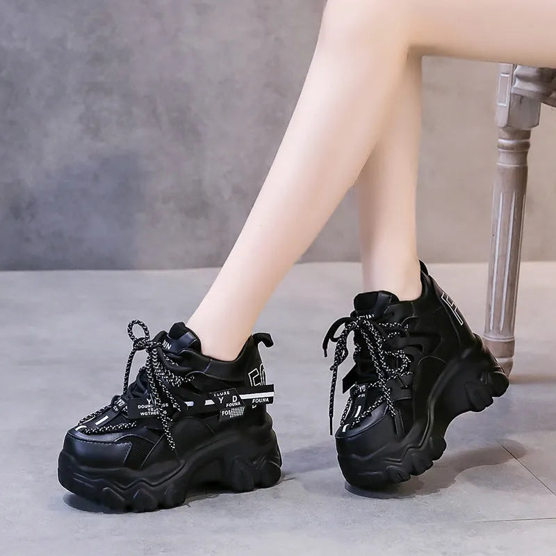 Women's white and black mesh platform sports shoes with cross-strap detail and rubber soles
