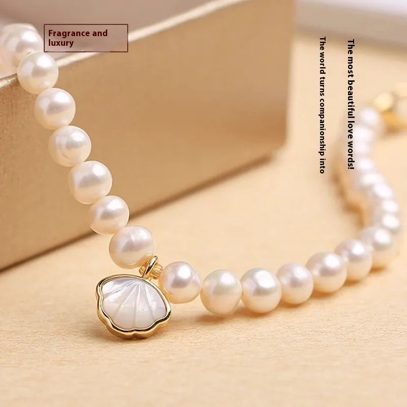 Women's freshwater pearl bracelet with fan-shaped design and alloy details.