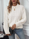 Women's loose beige round neck sweater showing twisted texture detail on the front.