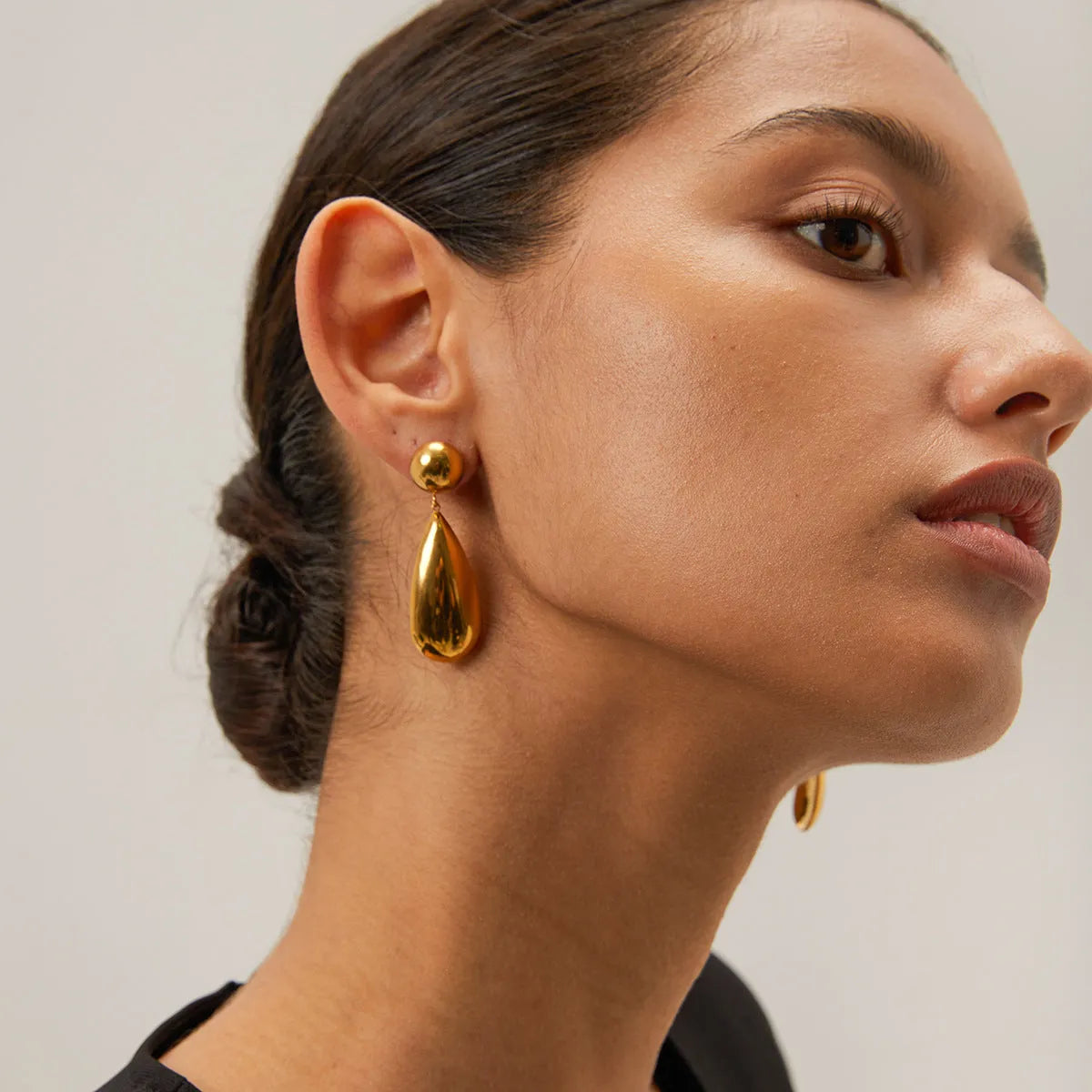 Gold-coloured stainless steel earrings with geometric water drop hemisphere pendant design