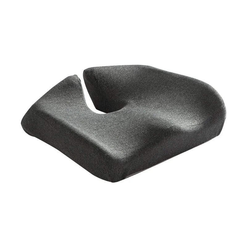 Dark grey memory foam office chair cushion with contoured shape for lower back support on a desk chair.