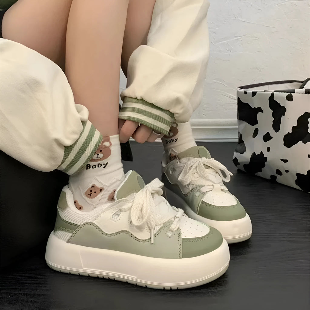 Green women's flat casual sneakers with a round toe and breathable PU mesh upper.