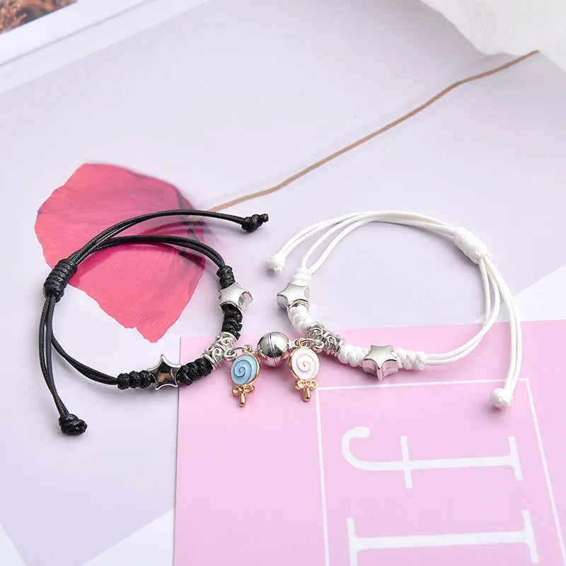 Pair of alloy suction bracelets with engraved symbol choices including crown, love lock, and clover.