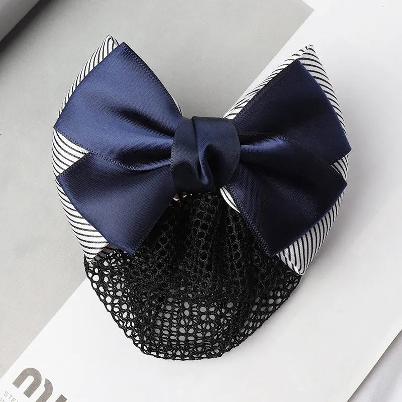 Professional flower bow headdress hair clip ornament on a work plate, shown in a selection of net and mesh colour variations.