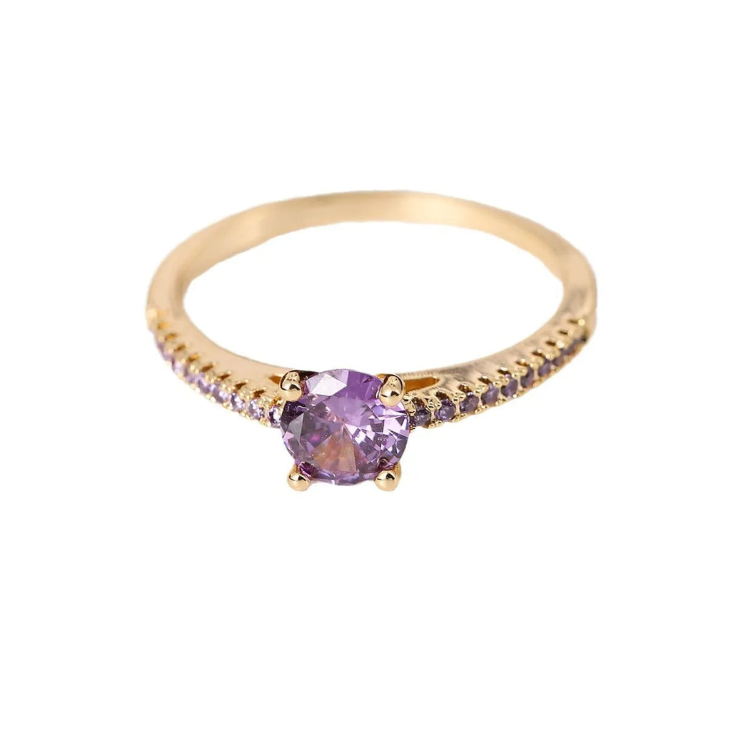 Hexagon geometric zircon ring on a finger, showing electroplated gold rose red colour and copper band.