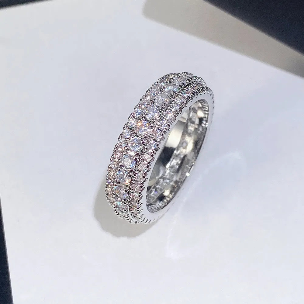 Geometric copper ring with triangular zircon inlay, shown in white gold plating.