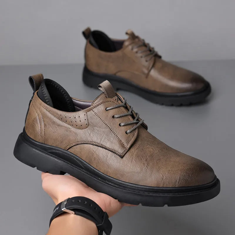 Men's black and brown leather casual sneakers with sewing line detail on the upper.