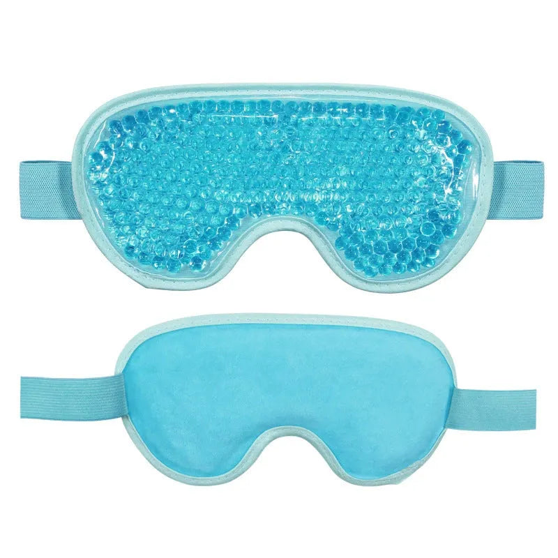 White portable rechargeable eye compress device with included eye mask on a grey background