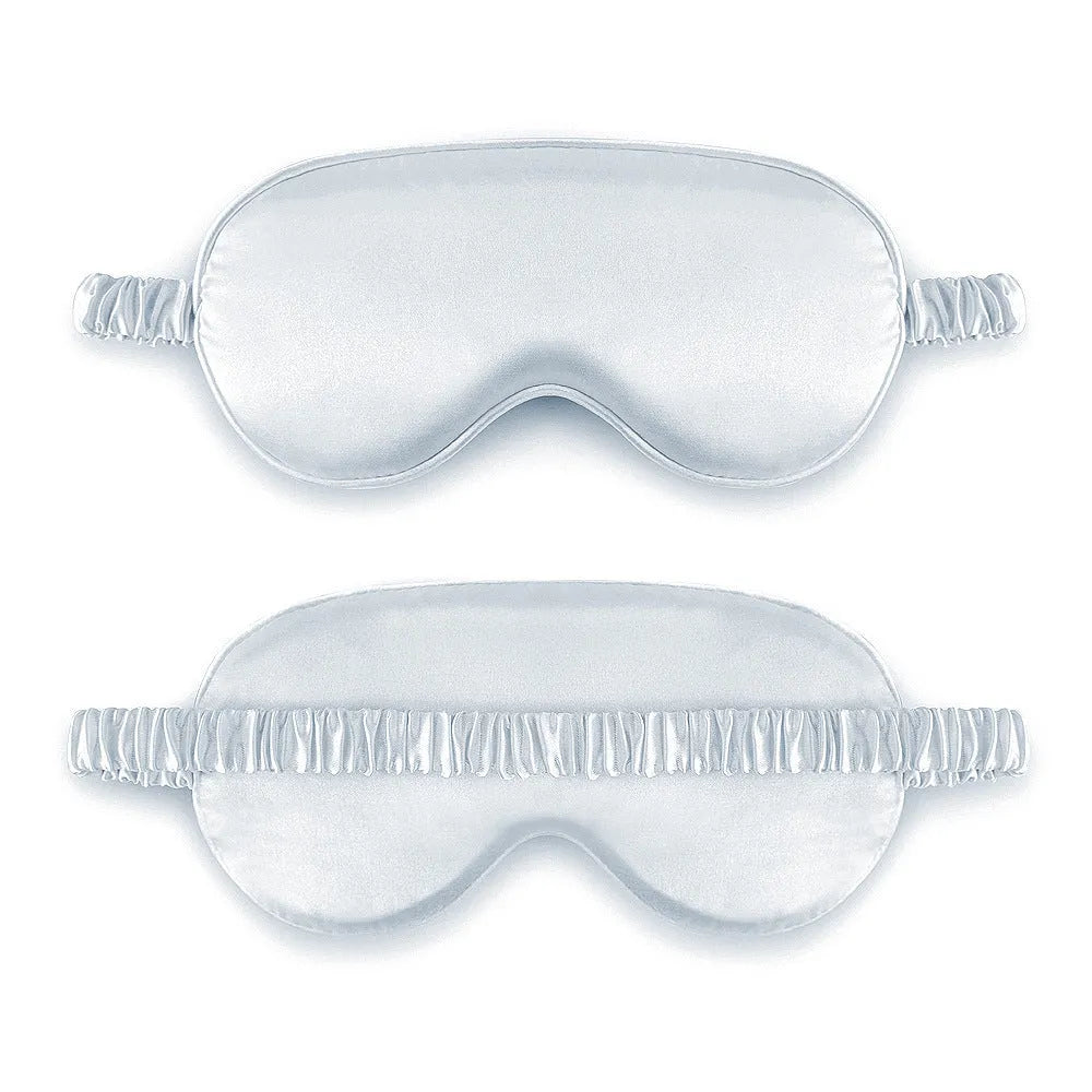 Reversible silk-like sleep eyeshade shown in multiple colour options including sky blue, wine red, and black.