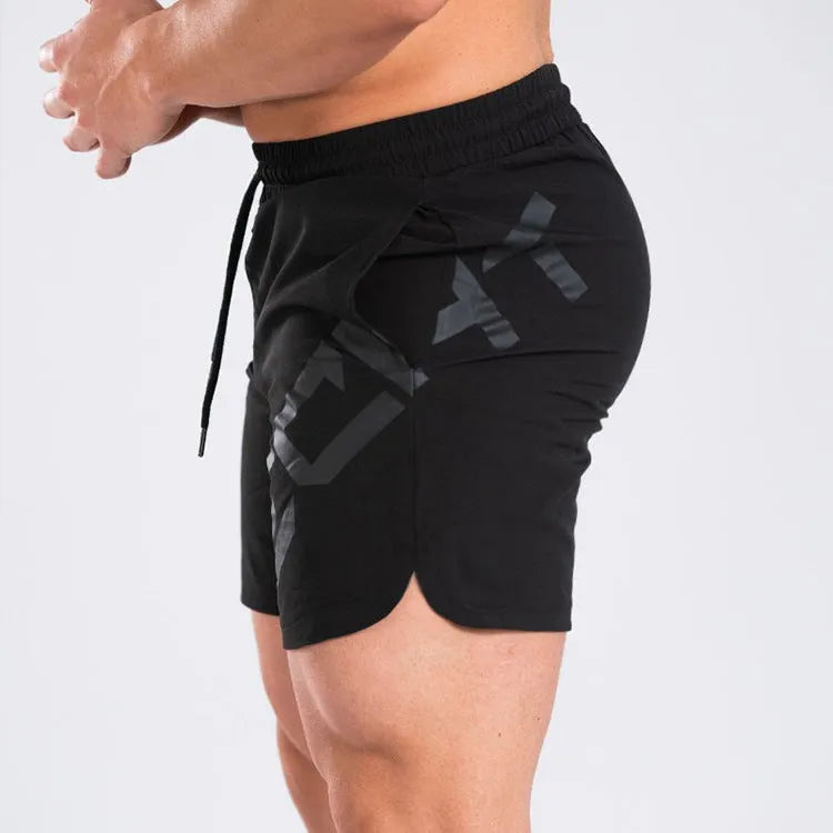 Men's black elastic training shorts with a knee-length cut on a plain background.