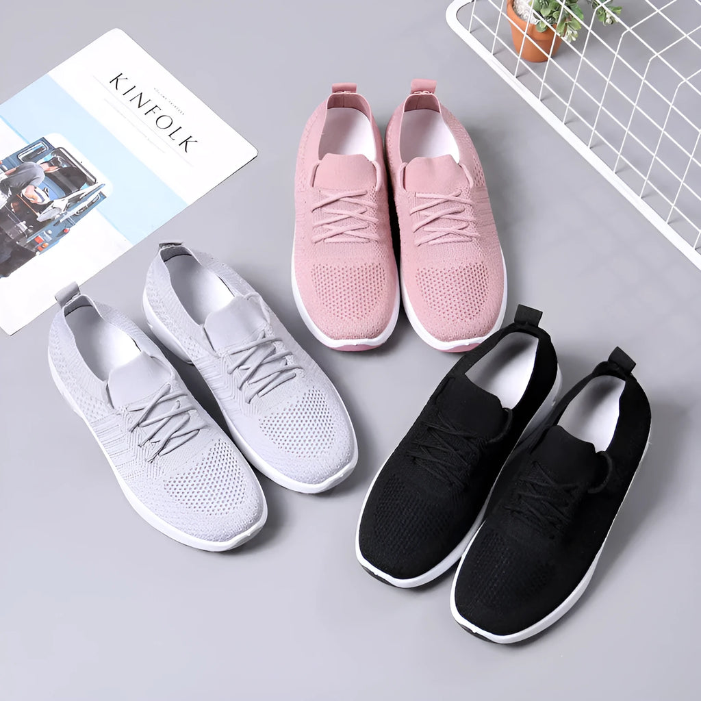 Women's black casual sneakers with mesh upper, lace-up front and soft PVC sole