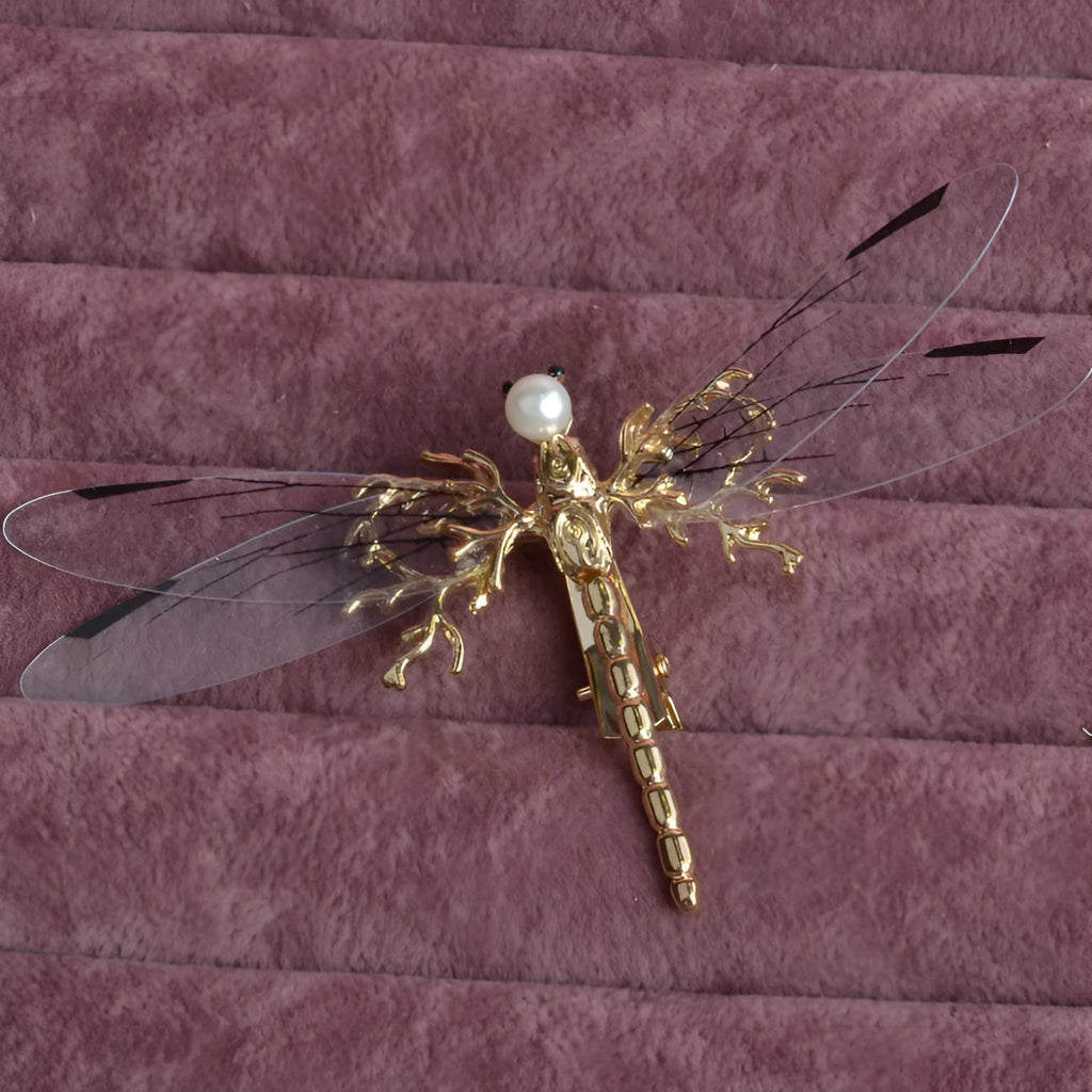 Golden dragonfly-shaped metal alloy headdress with a side clip for hair.