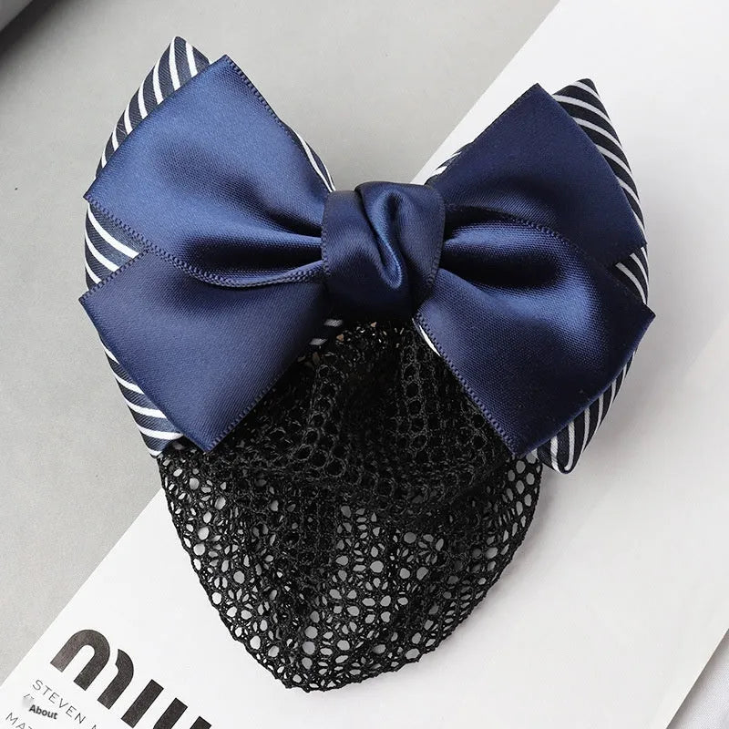 Professional flower bow headdress hair clip ornament on a work plate, shown in a selection of net and mesh colour variations.
