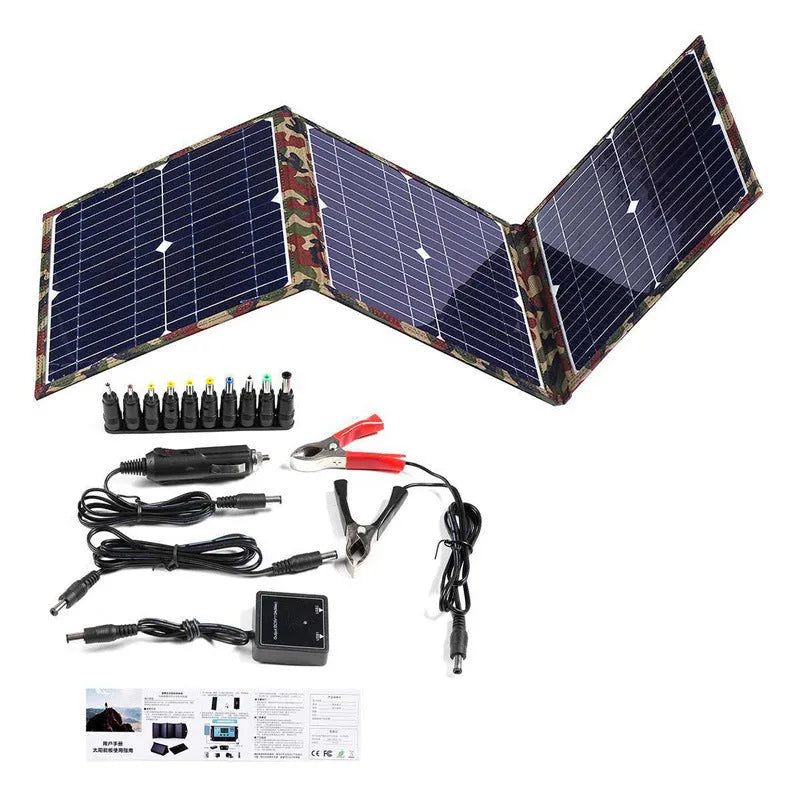 Black foldable portable solar panel unfolded, showing three monocrystalline cells, with included car charger and cables.