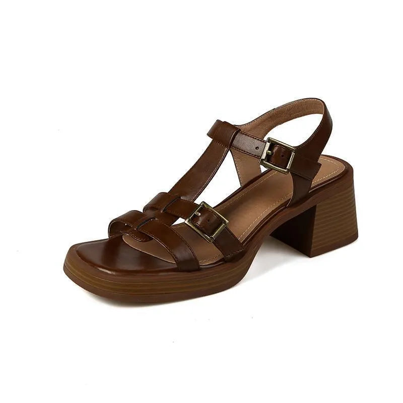 Black women's retro platform sandals with a T-buckle strap and chunky heel.