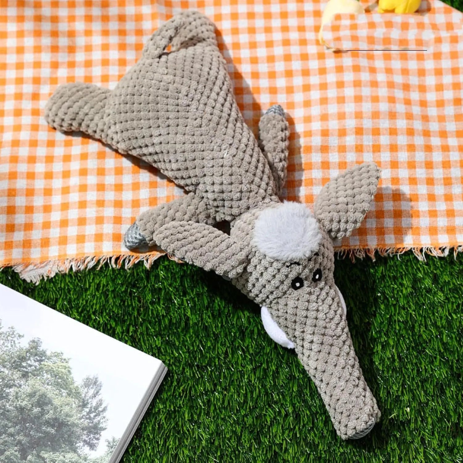 Four plush dog chew toys in green, grey and yellow with corn kernel texture design