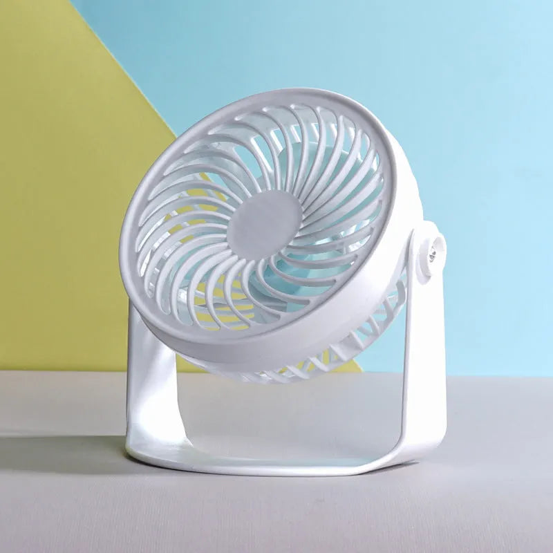 Compact USB desktop fan shown as both a clip-on model and a floor-standing model on a wooden desk.
