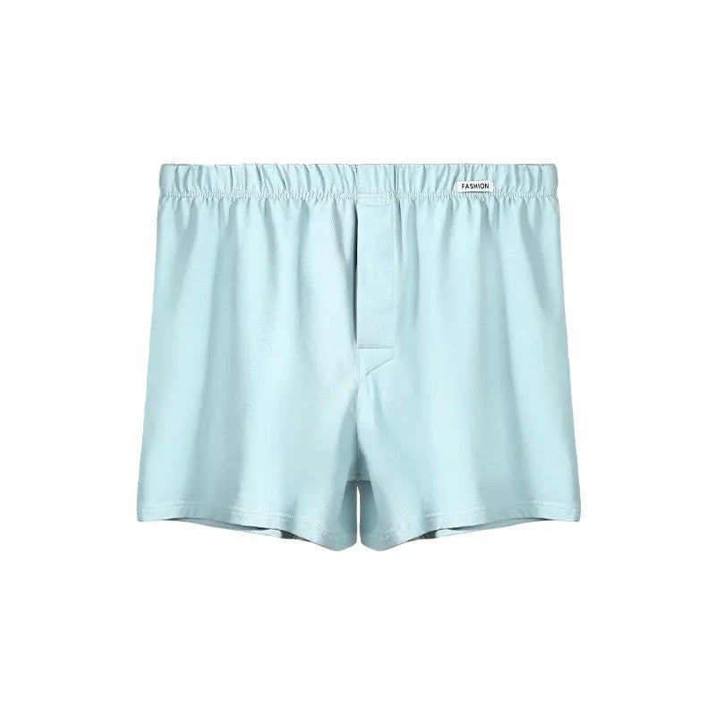 Men's loose-fitting cotton boxer shorts in a solid colour, shown in a light grey shade on a mid waist.