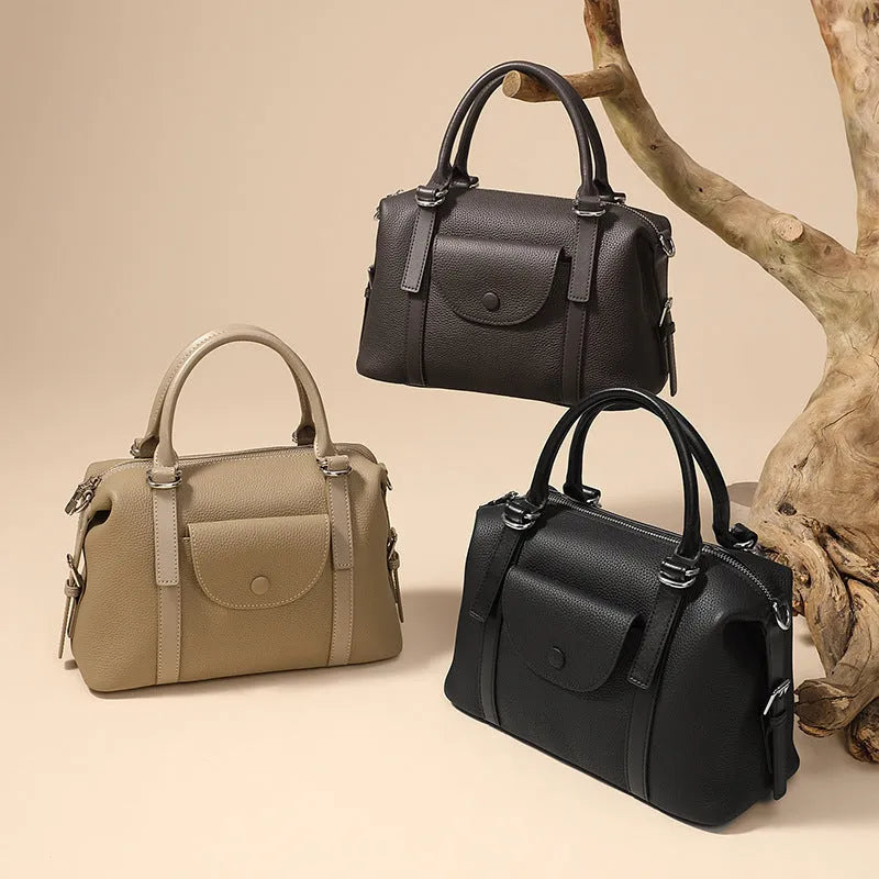 Genuine leather ladies handbag with contrast stitching and lock detail in street style